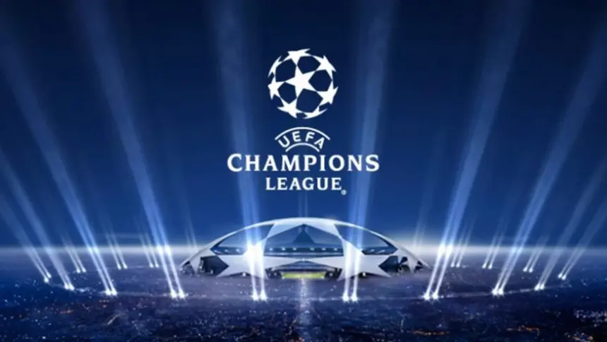 Logo da UEFA Champions League sobre fundo azul, com holofotes simulando luzes de estádio e uma representação estilizada de uma arena iluminada no centro.