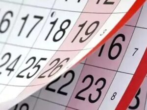 Calendário com página sendo virada, mostrando dias numerados em preto e marcações em vermelho.