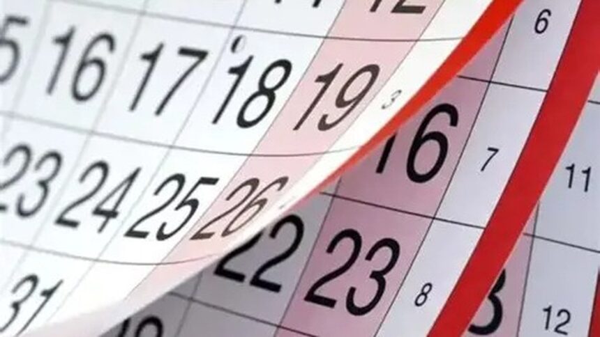 Calendário com página sendo virada, mostrando dias numerados em preto e marcações em vermelho.