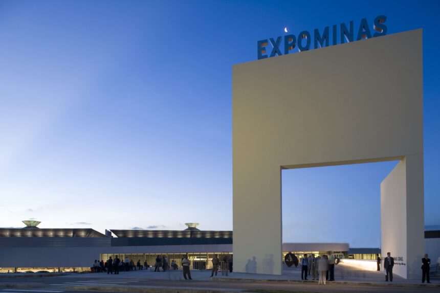 Fachada do Expominas com letras azuis "EXPOMINAS", lua crescente e céu azul.