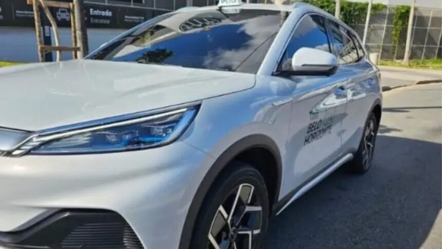 White modern SUV taxi with 'BELO HORIZONTE' logo parked on urban street