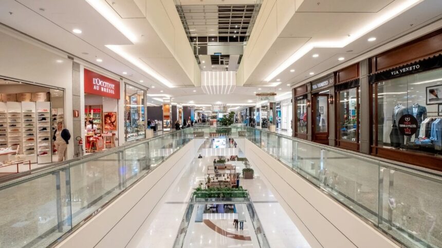 Interior de shopping moderno com lojas L'Occitane Au Brésil e Via Veneto, poucas pessoas