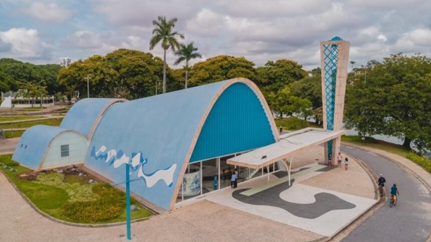 Vista aérea da Igreja da Pampulha, Belo Horizonte, com telhado azul, torre, pessoas e lago